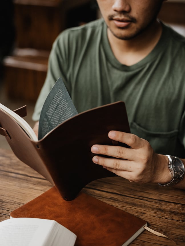 Man Reading a Book on Table
