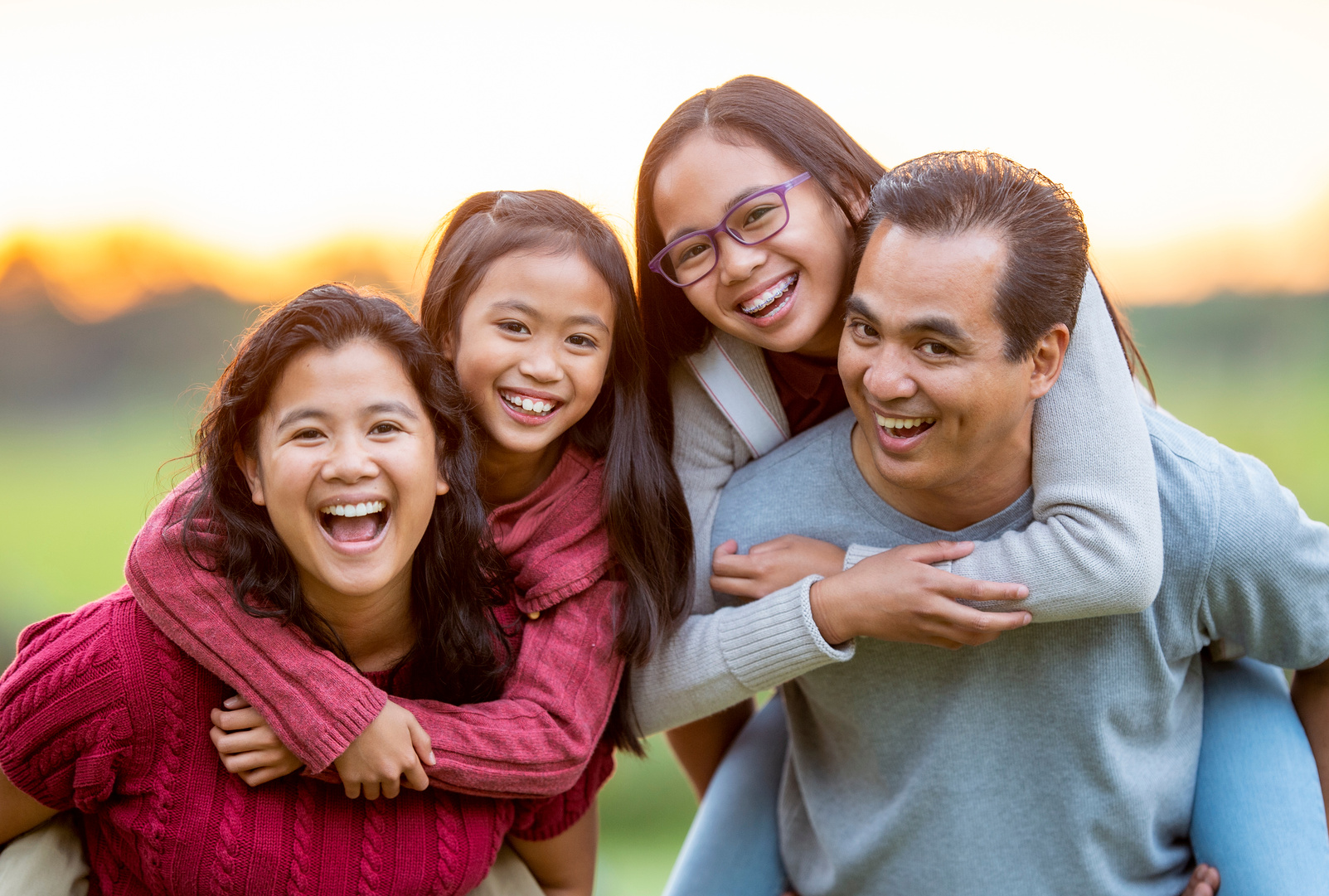 Filipino Family Laughing Piggyback Portrait stock photo